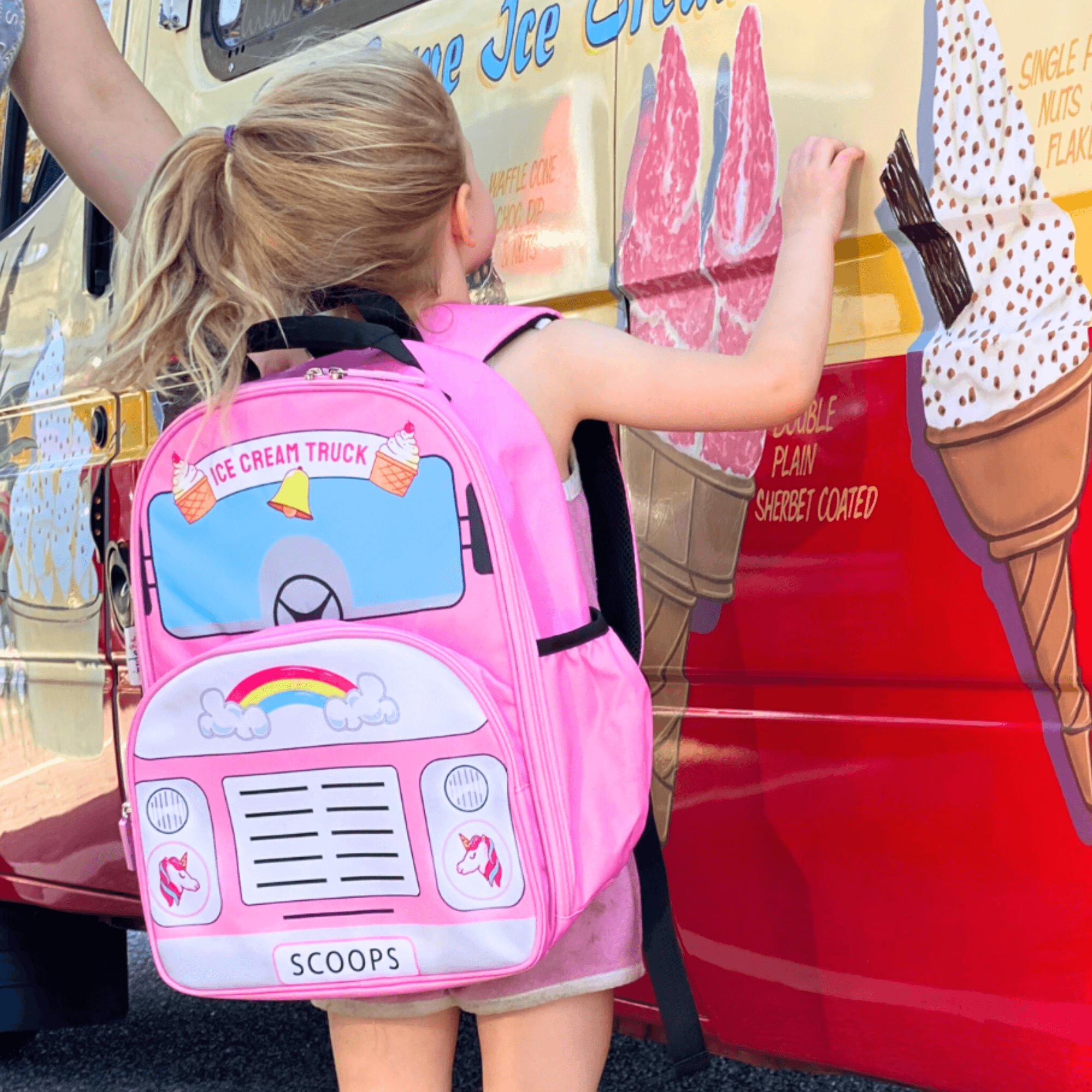 Girl wearing jude&moo Ice cream Truck Kids backpack with unicorns and rainbows